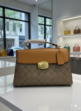 CO ACH GEORGIE SATCHEL IN SIGNATURE CANVAS WITH TAN LEATHER  LADIES SLING BAG